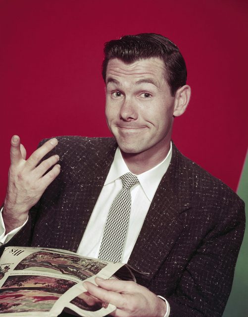 young Johnny Carson against a red background