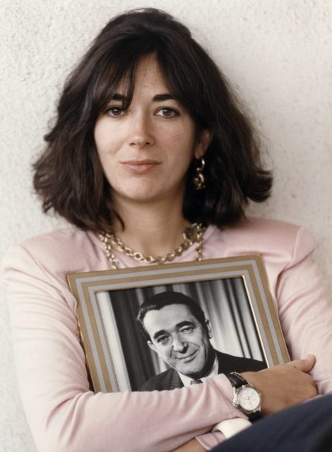 Ghislaine Maxwell holding a photo of her father