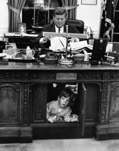 John F. Kennedy jr. exploring Kennedy's desk 