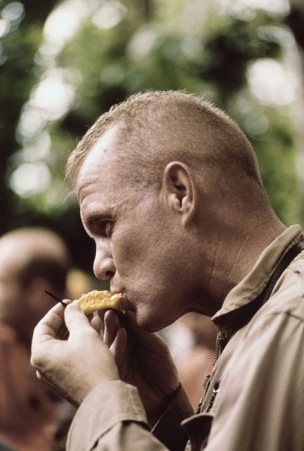 John Glenn eating a piece of fruit