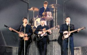 The Beatles performing on stage