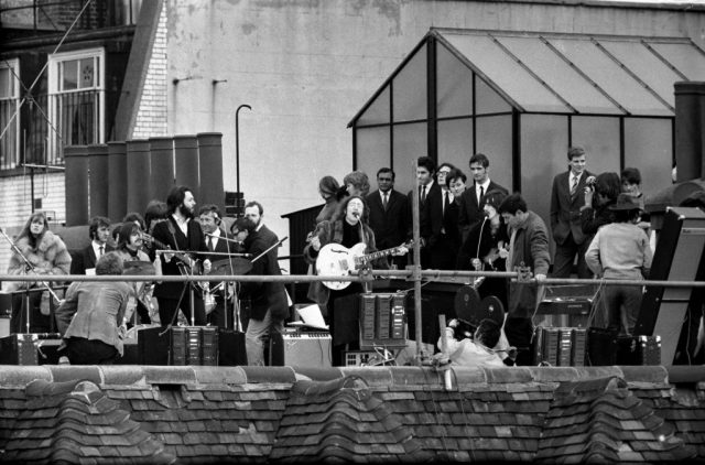 The Beatles performing on a rooftop