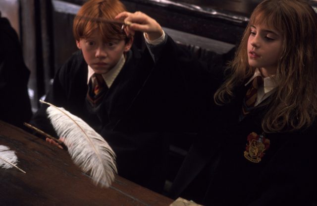 Ron Weasley watching as Hermione Granger perfectly executes the Wingardium Leviosa charm