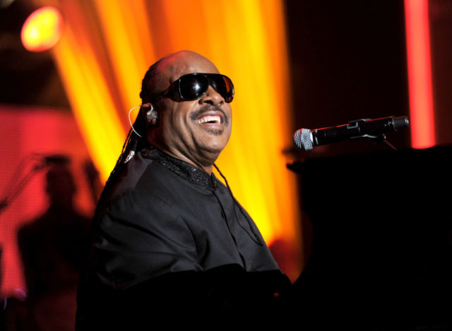 Stevie Wonder plays piano on stage