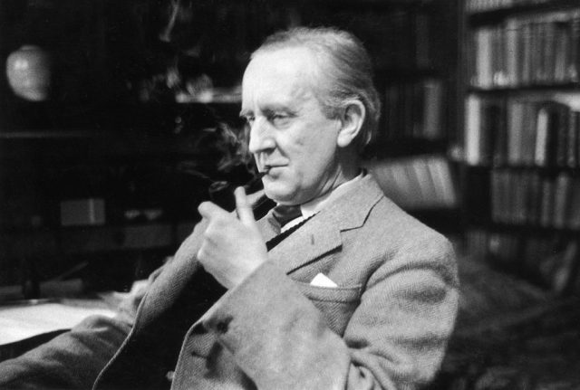 British writer J R R Tolkien enjoying a pipe in his study
