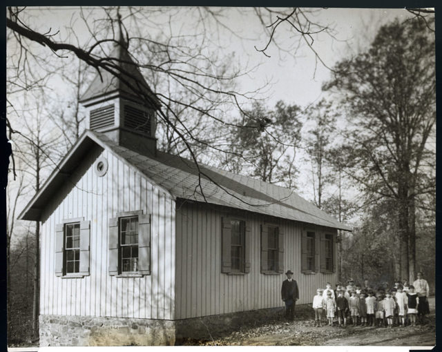 a New Jersey schoolhouse with a teacher and students