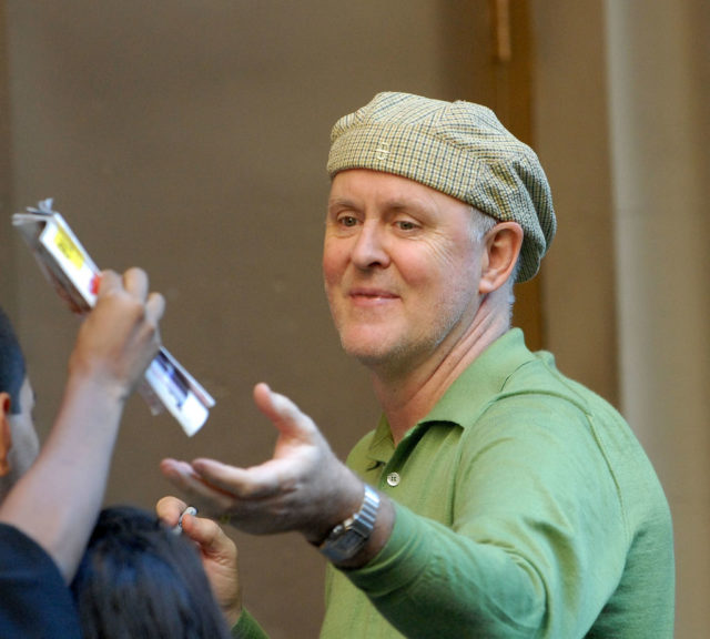  John Lithgow exits the stage door of a theater