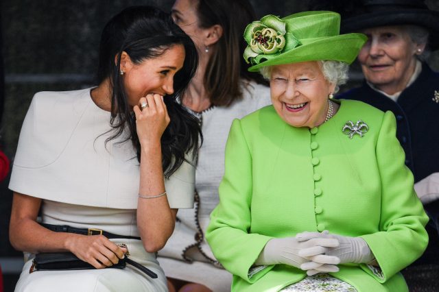 Queen Elizabeth II sits and laughs with Meghan, Duchess of Sussex