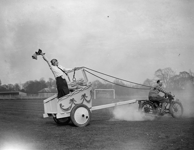 Two men participating in motorcycle chariot racing