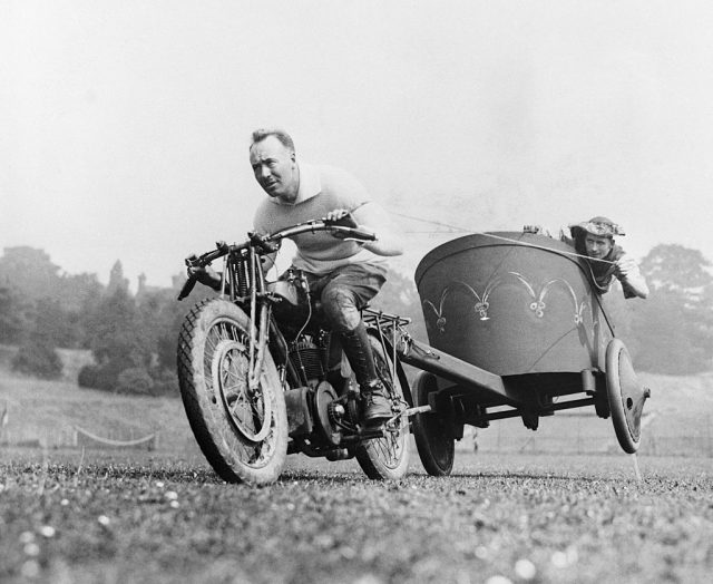 Two men participating in motorcycle chariot racing