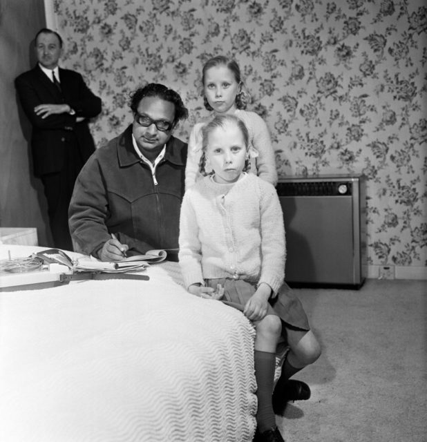 The Pollock twins, Gillian and Jennifer. Their father believes they are reincarnations of his two daughters, Joanne and Jacqueline who were killed in 1957. Dr Banerjee has come over from India to interview the two girls in connection with his research into extra sensory perception, telepathy etc. Pictured, Dr Hemendra Banerjee with Jennifer and Gillian Pollock, 11th April 1966. (Photo Credit: Chris Paterson/Mirrorpix/Getty Images)