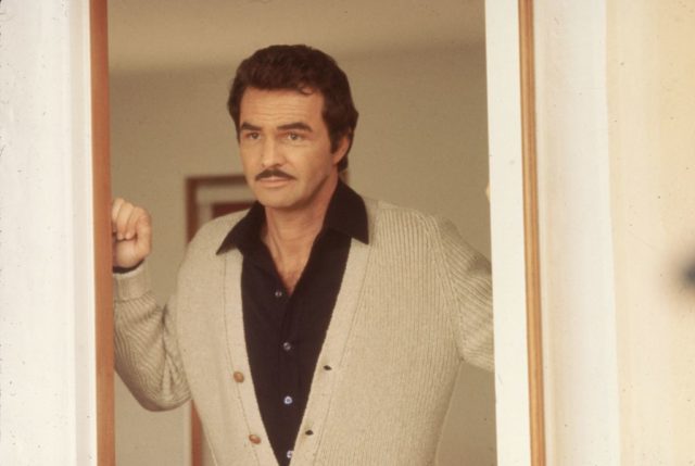  Burt Reynolds stands in a doorway