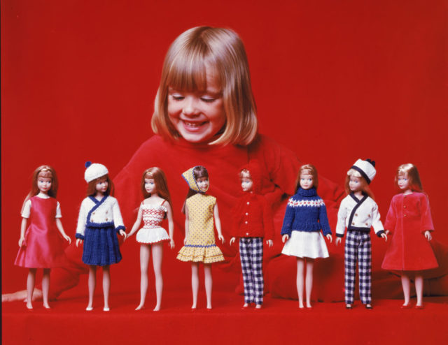 A girl dressed in red with her toys