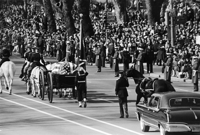 A horse-drawn caisson carrying the body of John Fitzgerald Kennedy passes mourners lining the streets of Washington from the White House to the Capitol. (Photo Credit: Wally McNamee/CORBIS/Corbis via Getty Images)
