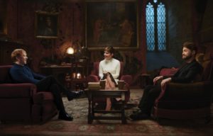 Rupert Grint, Emma Watson and Daniel Radcliffe sitting in chairs