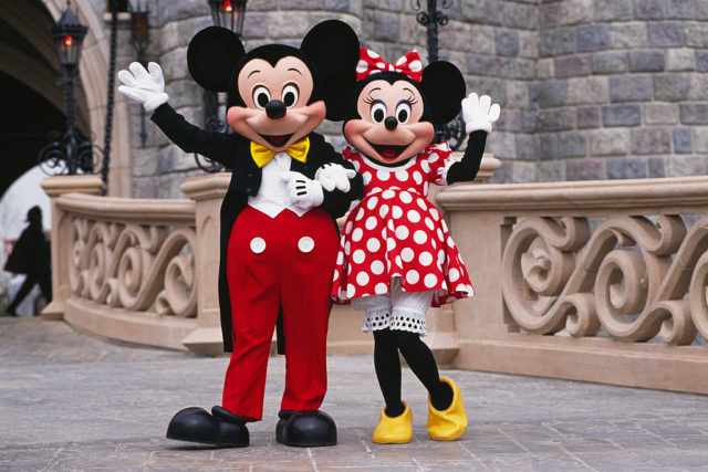 Mickey and Minnie Mouse waving