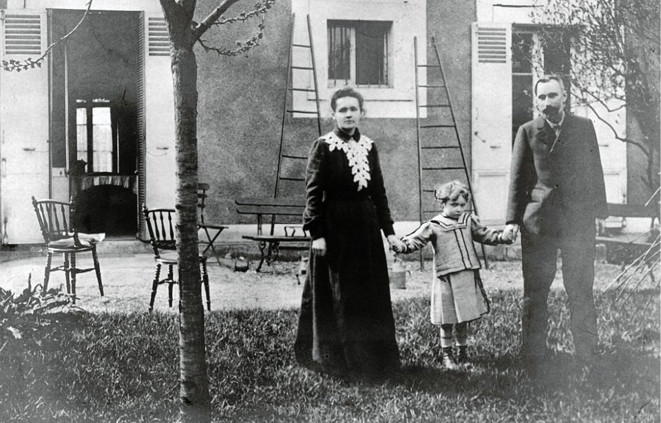 Polish-born physicist Marie Curie (1867-1934) and her husband, French chemist Pierre Curie (1859-1906), hold hands with their daughter, Irene, in the garden of their home near Paris, France. (Photo Credit: Hulton Archive/Getty Images)