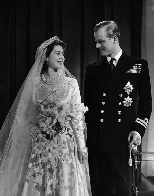 Queen Elizabeth II and Prince Philip smiling at each other on their wedding day