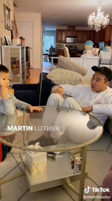 Chris Cho sitting around a glass coffee table with his nephew