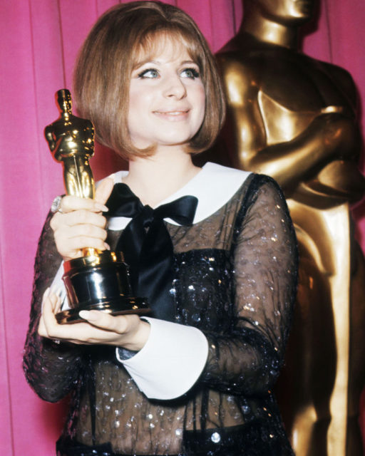 Barbara Streisand holding her Oscar for Best Actress 