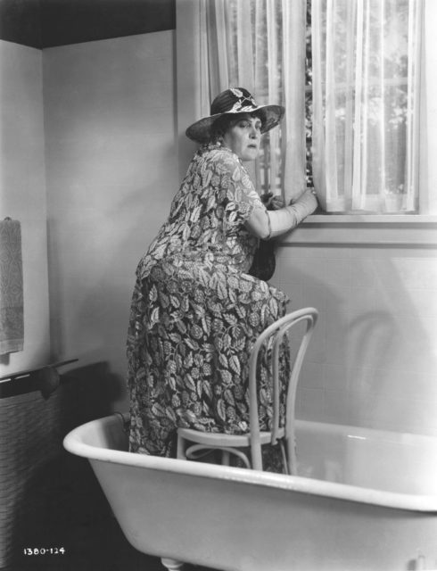 Woman standing in bathtub