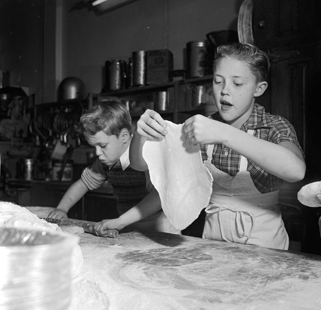 a young Christopher kneading dough