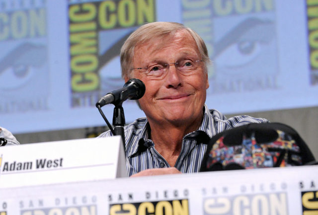 Adam West sits at a convention