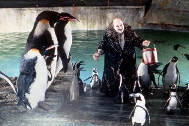 Danny DeVito surrounded by Penguins