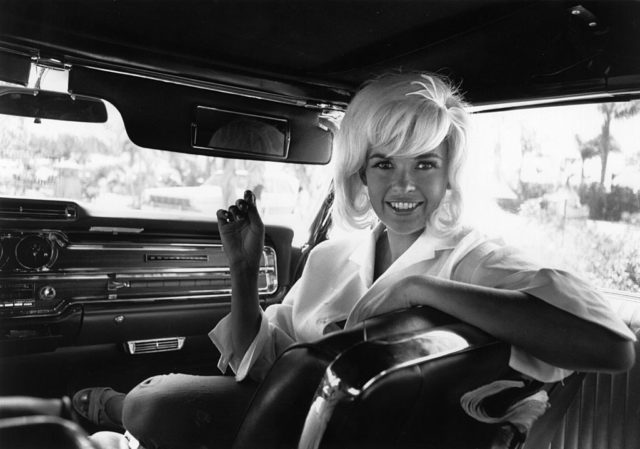 Jayne Mansfield sits in the passenger sear of a limousine 
