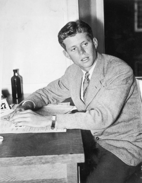 John F. Kennedy sitting at a desk