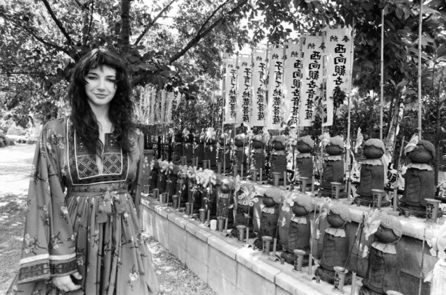 Kate Bush standing in front of the Jizo Bosatu Statue