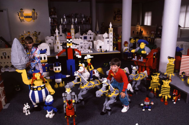 Children sitting among LEGO sculptures
