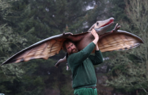 James Quickenden carrying a pterosaur statue