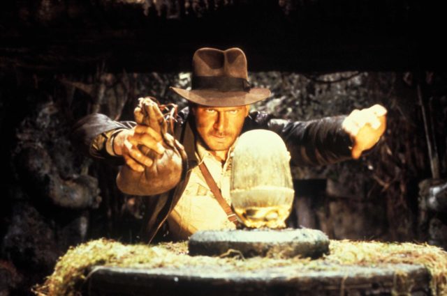 Indiana Jones about to grab an artifact