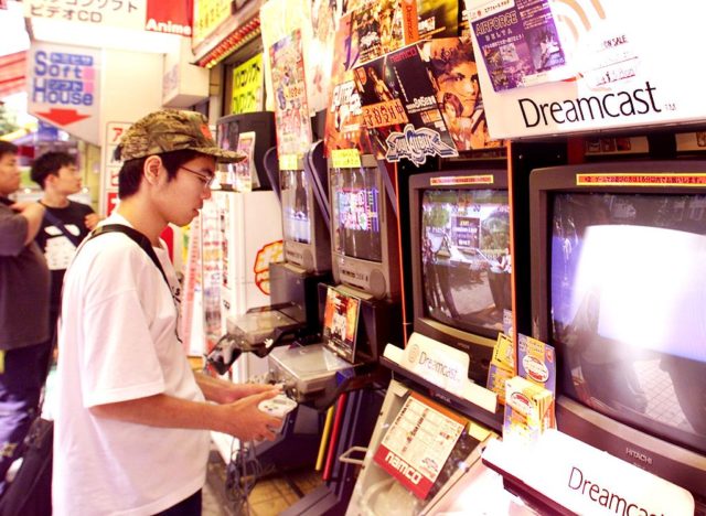 Teenage boy playing a SEGA Dreamcast console