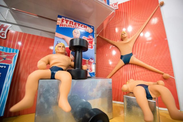 Three Stretch Armstrong toys on display