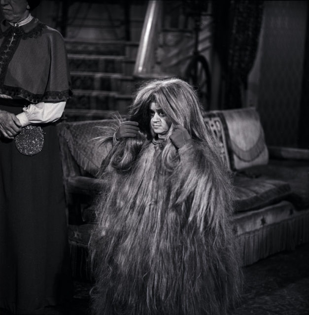 Cousin Itt standing in the Addams family's house