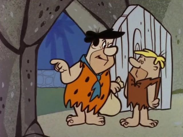 Fred Flintstone angrily pointing while speaking with Barney Rubble