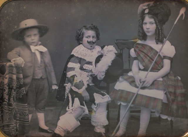 Three children dressed up 1850s 