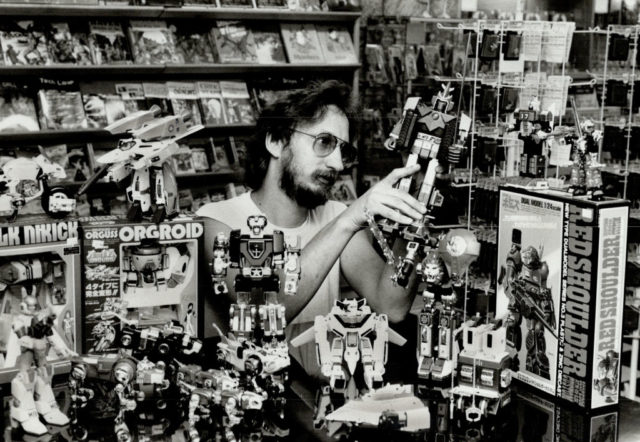 Ron Van Leeuwen surrounded by Transformer toys and boxes