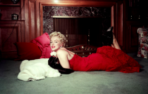 Marilyn Monroe lying in front of a fireplace