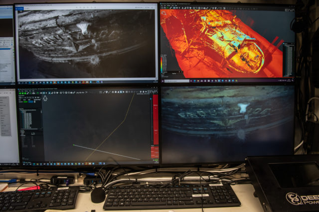 Four computer screens showing underwater footage of Endurance