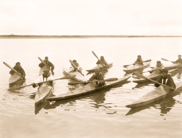 Eskimos in kayaks in Alaska 