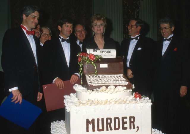 Angela cutting a celebratory cake