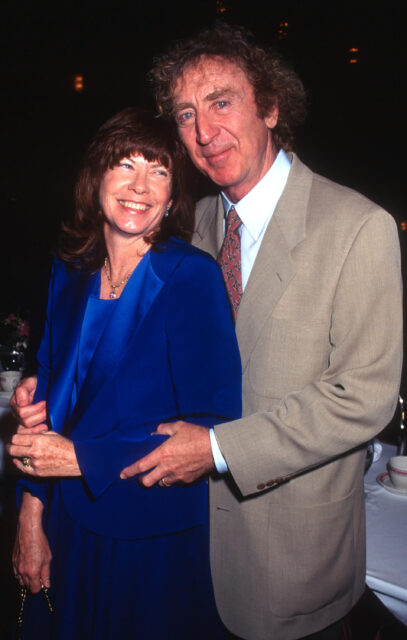 Gene Wilder hugs wife Karen Boyer from behind.