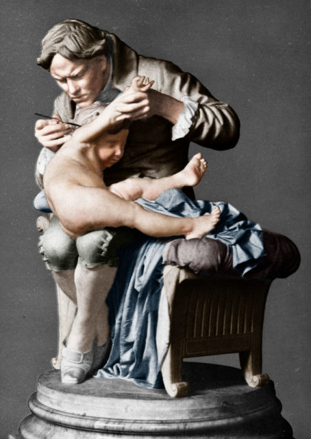 Edward Jenner, English physician, vaccinating his son. Colourised artwork based on an original sculpture. Artist Giulio Monteverde. (Photo Credit: The Print Collector/Getty Images)