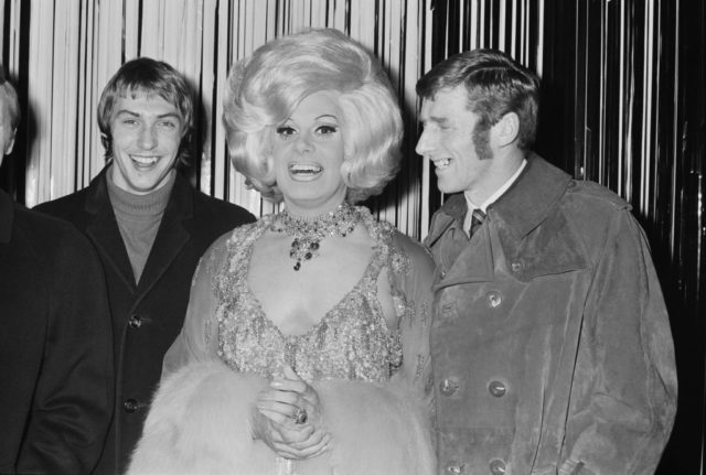 Danny La Rue pictured with two footballers
