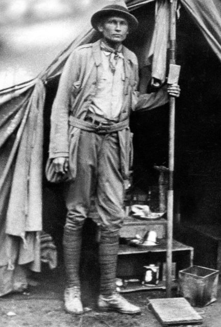 Hiram Bingham standing outside a tent