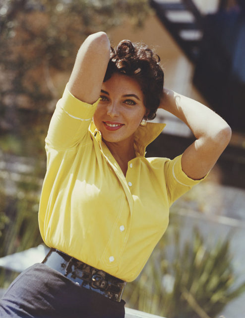 Joan Collins wearing a yellow blouse, 1960 