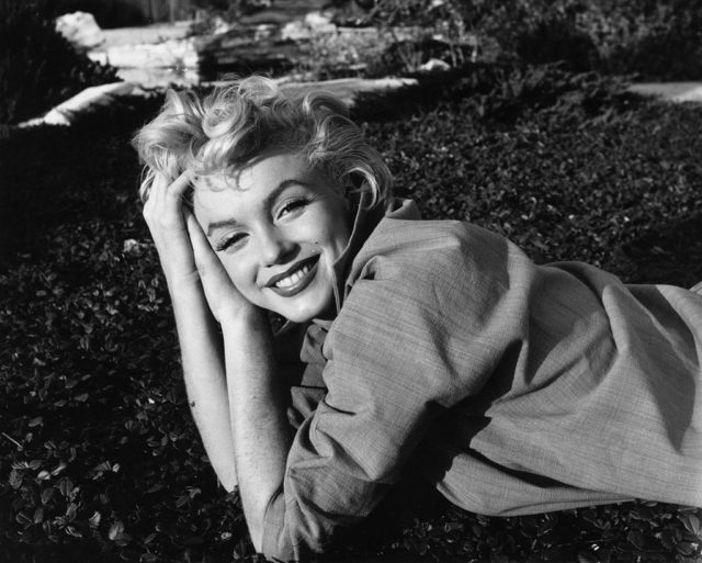 Marilyn Monroe lying on her stomach during a photoshoot